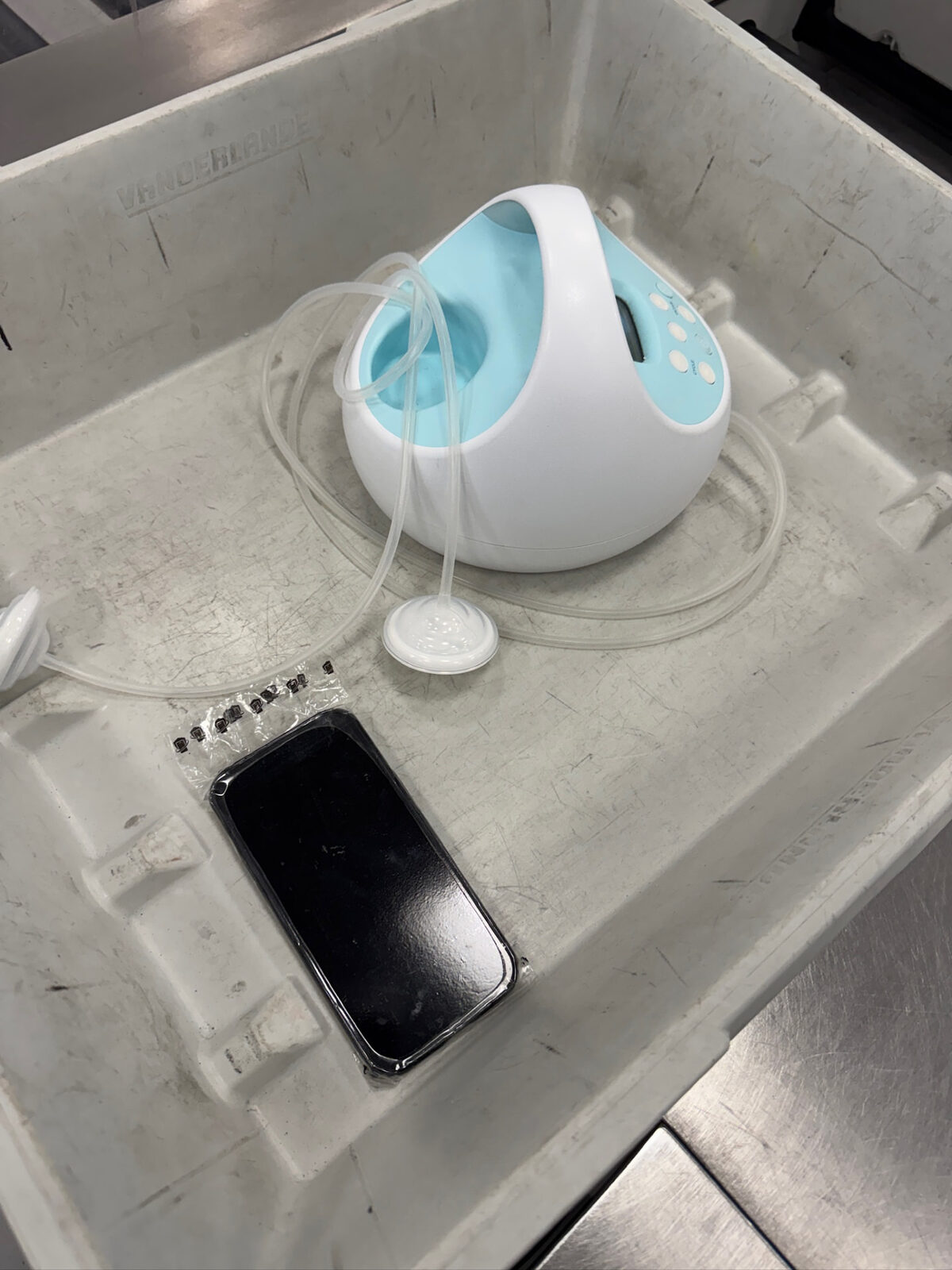 WynnShield™-wrapped phone in an airport security bin